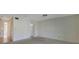 Open-concept living room with neutral walls and carpeted flooring, plus doorway to other rooms at 3312 Northcrest Rd # C, Atlanta, GA 30340