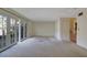 Spacious living room featuring a door that leads to the backyard, and a stairway to the second floor at 3312 Northcrest Rd # C, Atlanta, GA 30340