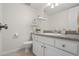 Clean bathroom featuring a white vanity with granite countertops, toilet, and decorative shelf at 3689 Essex Ave # 16, Atlanta, GA 30339