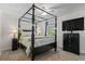 Bedroom featuring a four-poster bed, neutral walls, soft carpet and dark furniture pieces at 3689 Essex Ave # 16, Atlanta, GA 30339