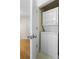 Convenient laundry area featuring a stacked washer and dryer, accessible through a hallway with wood flooring at 3689 Essex Ave # 16, Atlanta, GA 30339