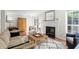 Bright living room with a cozy fireplace, wood floors, and comfortable furnishings perfect for relaxing and entertaining at 3689 Essex Ave # 16, Atlanta, GA 30339