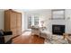 Cozy living room with hardwood floors, fireplace, and French doors to the outdoors at 3689 Essex Ave # 16, Atlanta, GA 30339