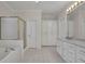 Bathroom featuring a tub, shower, white cabinetry, and tiled flooring, perfect for relaxation at 4650 Riversound Dr, Snellville, GA 30039