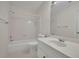 Bright bathroom features white vanity, tiled shower, and large mirror at 4650 Riversound Dr, Snellville, GA 30039