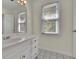 Bathroom featuring a vanity, mirror, and tiled flooring, enhancing the home's comfort at 4650 Riversound Dr, Snellville, GA 30039