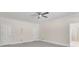 Spacious bedroom features neutral tones, carpeted flooring, and a modern ceiling fan at 4650 Riversound Dr, Snellville, GA 30039