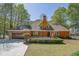 Charming brick home with attached garage, brick barbeque and landscaped front yard at 4650 Riversound Dr, Snellville, GA 30039