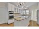 Modern kitchen with stainless steel appliances, granite countertops, and kitchen island at 4650 Riversound Dr, Snellville, GA 30039