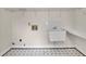 White laundry sink with hanging shelf at 4650 Riversound Dr, Snellville, GA 30039