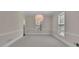 Bright living room with neutral walls, carpeting, and a stylish pendant light at 4650 Riversound Dr, Snellville, GA 30039