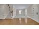 Inviting living room featuring hardwood floors, a staircase, and a modern light fixture at 4650 Riversound Dr, Snellville, GA 30039