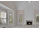 Cozy living room with a fireplace, vaulted ceilings, and large windows at 4650 Riversound Dr, Snellville, GA 30039