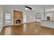 Open living room with brick fireplace, ceiling fan, and hardwood floors at 4650 Riversound Dr, Snellville, GA 30039