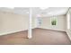 Carpeted basement area with natural light from two windows and a support pillar at 503 Clearwater Dr, Mcdonough, GA 30252