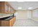 Basement bar area with sink, wooden cabinets, and white refrigerator at 503 Clearwater Dr, Mcdonough, GA 30252