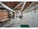A large basement with concrete walls, ceiling pipes, and space for storage at 503 Clearwater Dr, Mcdonough, GA 30252