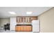 Basement area with cabinets, sink, black countertop, and a white refrigerator at 503 Clearwater Dr, Mcdonough, GA 30252