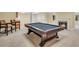 Basement with pool table, bar chairs, and cozy fireplace with a mantle at 503 Clearwater Dr, Mcdonough, GA 30252