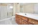 Bathroom features a walk-in shower, ceramic tile, and a wooden cabinet with white countertop at 503 Clearwater Dr, Mcdonough, GA 30252
