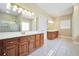 Bathroom boasting double sink vanity with a gold-trimmed shower and large bright window at 503 Clearwater Dr, Mcdonough, GA 30252