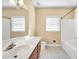 Bright bathroom featuring vanity with sink, ample lighting, a white bathtub and a toilet at 503 Clearwater Dr, Mcdonough, GA 30252