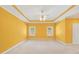 Bedroom featuring yellow walls, white trim, carpet flooring, windows, and a ceiling fan at 503 Clearwater Dr, Mcdonough, GA 30252
