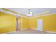 A primary bedroom features yellow walls, white trim, a ceiling fan, and carpet flooring at 503 Clearwater Dr, Mcdonough, GA 30252