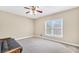 Bright bedroom features a ceiling fan, neutral walls, carpet, and a window with views at 503 Clearwater Dr, Mcdonough, GA 30252