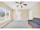 Bright bedroom features a ceiling fan, neutral walls, carpet, and a window with views at 503 Clearwater Dr, Mcdonough, GA 30252