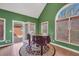 Bright bonus room with piano, tile flooring, and large windows overlooking the backyard at 503 Clearwater Dr, Mcdonough, GA 30252