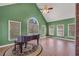 Spacious living room features a piano, tile flooring, and vaulted ceilings at 503 Clearwater Dr, Mcdonough, GA 30252