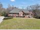 Well-maintained brick home with a spacious front lawn, mature landscaping, and a side-entry garage at 503 Clearwater Dr, Mcdonough, GA 30252