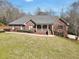 Charming brick home with mature trees, landscaping, and a covered front porch at 503 Clearwater Dr, Mcdonough, GA 30252