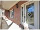 Elegant front door with decorative glass, sidelights, and a covered porch with brick accents at 503 Clearwater Dr, Mcdonough, GA 30252