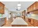 Large kitchen with an island, stainless steel appliances, hardwood floors, and a built-in workspace at 503 Clearwater Dr, Mcdonough, GA 30252