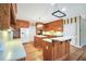 Charming kitchen features warm wood cabinets, white countertops, and stainless steel appliances at 503 Clearwater Dr, Mcdonough, GA 30252