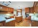 Open kitchen featuring hardwood floors, wood cabinets, and modern stainless steel appliances at 503 Clearwater Dr, Mcdonough, GA 30252