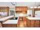 Spacious kitchen featuring hardwood floors, white countertops, and natural wood cabinetry with modern appliances at 503 Clearwater Dr, Mcdonough, GA 30252