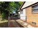 Backyard featuring a fenced yard, brick siding, and additional parking area, surrounded by greenery at 1029 Katherwood Sw Dr, Atlanta, GA 30310