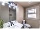 Bright bathroom with a modern vanity, accent lighting, tile surround, and window at 1029 Katherwood Sw Dr, Atlanta, GA 30310