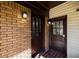 Close-up of the front entryway featuring a brick facade and stained glass accent windows at 1029 Katherwood Sw Dr, Atlanta, GA 30310