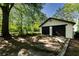 Spacious two-car garage with a concrete driveway and plenty of surrounding greenery at 1029 Katherwood Sw Dr, Atlanta, GA 30310
