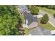 Aerial view of a tan brick house showcasing the backyard, roof, and surrounding greenery at 118 Bellington Dr, Mcdonough, GA 30253