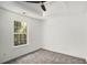 Sunlit bedroom with soft carpet, trey ceiling, and large window overlooking backyard at 118 Bellington Dr, Mcdonough, GA 30253