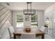 Inviting dining room featuring stylish wainscoting, chandelier, and wood table at 118 Bellington Dr, Mcdonough, GA 30253