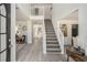 Bright entryway with staircase, light grey flooring and open view of the living areas at 118 Bellington Dr, Mcdonough, GA 30253