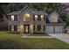 Charming two-story brick home featuring a well-manicured lawn and an attached two-car garage at 118 Bellington Dr, Mcdonough, GA 30253