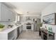 Contemporary kitchen features stainless steel appliances, light grey cabinets, and subway tile backsplash at 118 Bellington Dr, Mcdonough, GA 30253
