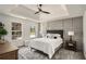 Serene main bedroom with modern furnishings, wainscoting detail, and tray ceiling at 118 Bellington Dr, Mcdonough, GA 30253